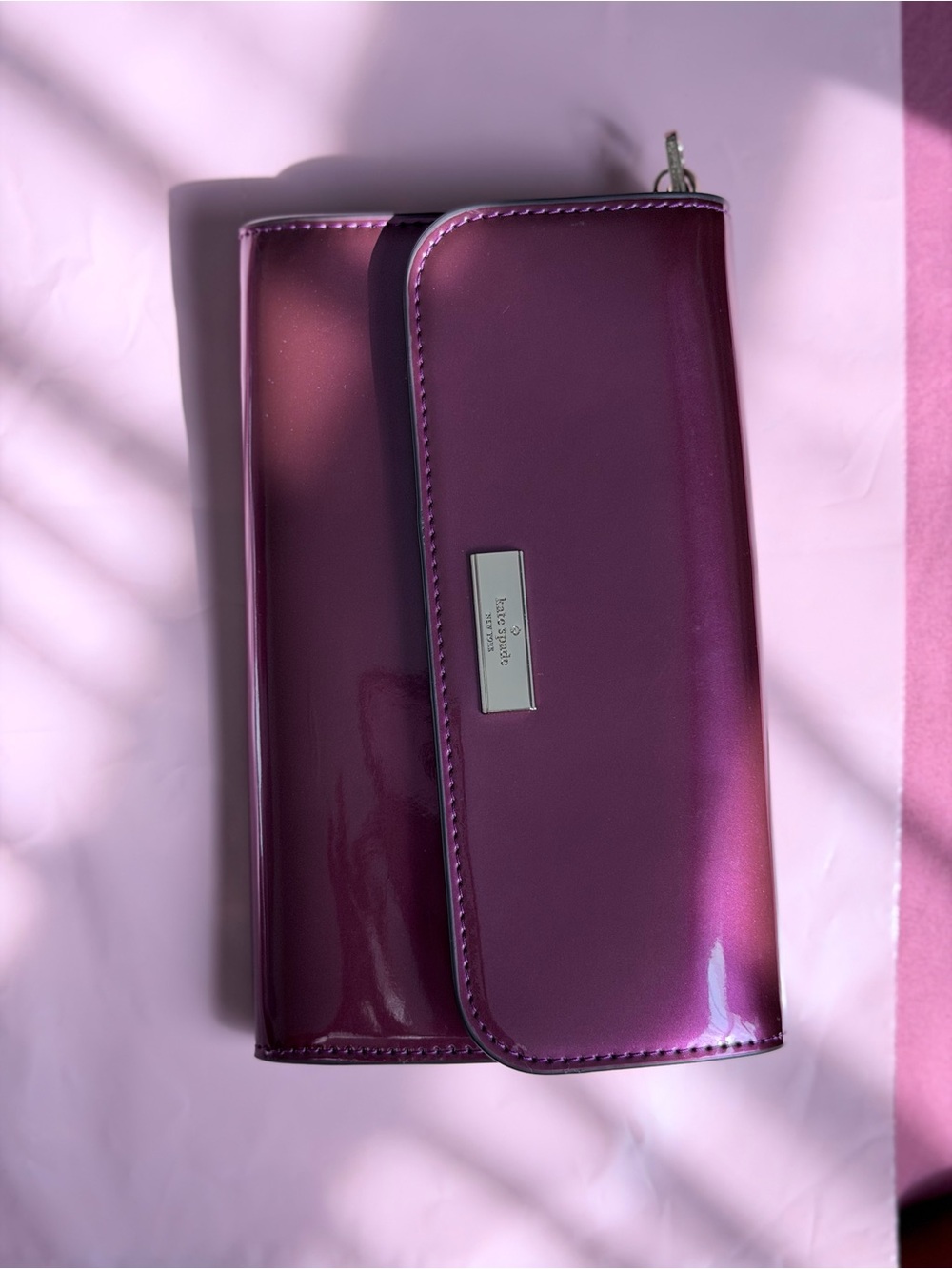 kate spade glossy magenta patent leather clutch with metal logo plate